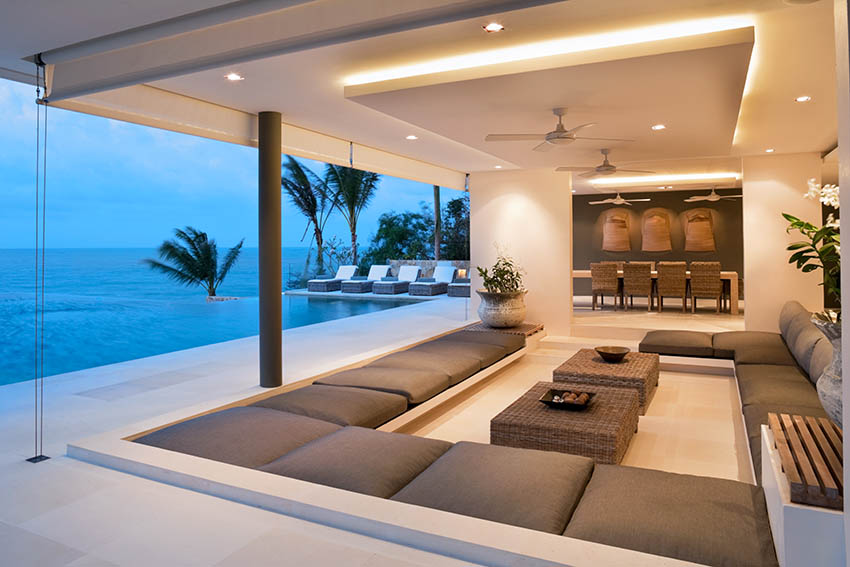 Indoor outdoor living room with false ceiling and cove lighting