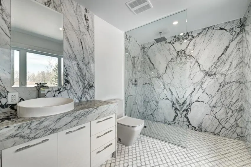 Marble wall countertop mirror sink0tile floor open shower concept bathroom