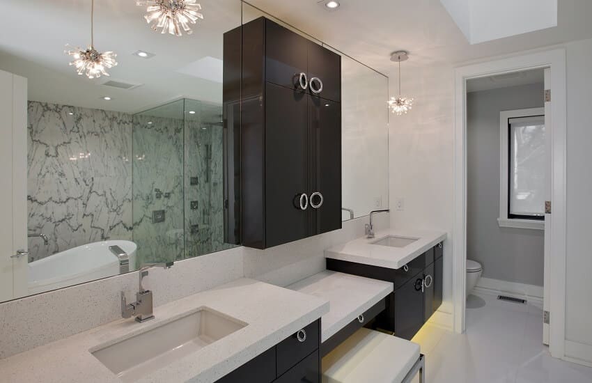 Bathroom with white walls and countertops, dark brown cabinets and tile flooring