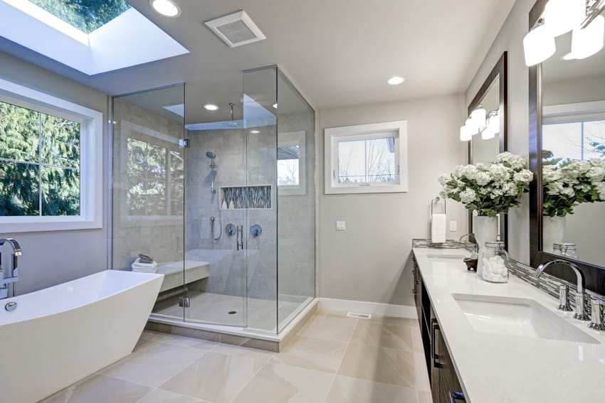 Master bathroom with dark wood vanity arctic white quartz countertop freestanding tub