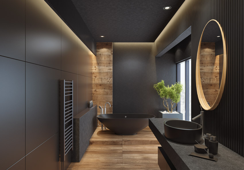 Matte black bathroom fixtures wood floor sink mirror countertop tub windows