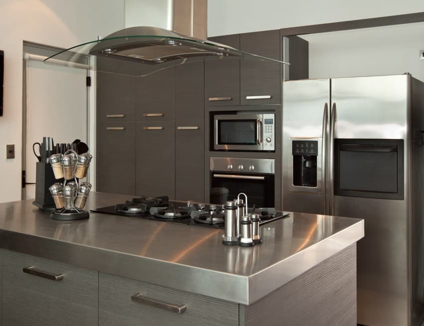 Metal kitchen countertop gray cabinets hood stove white wall