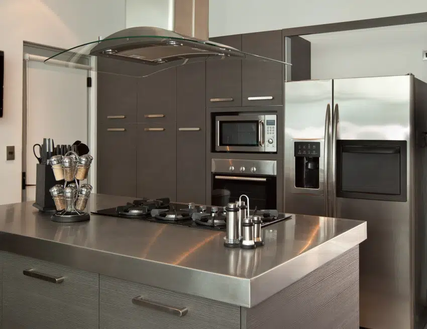 Kitchen with gray cabinets, hood and tabletop kitchen accessories