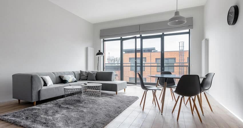 Minimalist room with gray walls and big balcony windows