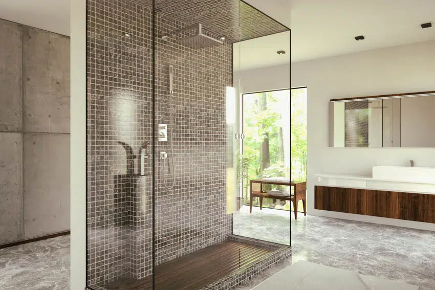 Bathroom with glasst tile walls in the shower area, white vanity area and mirror