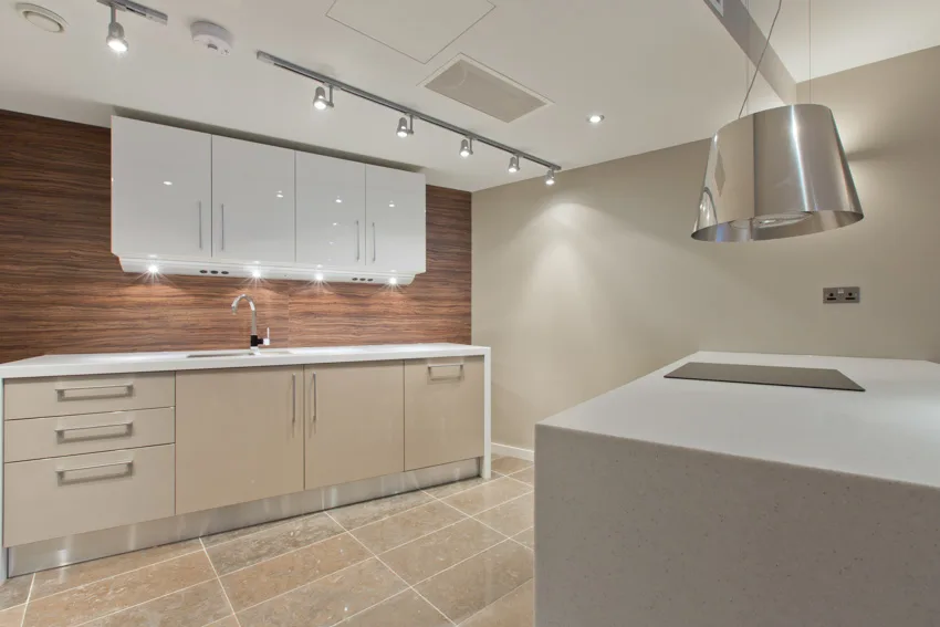 Modern kitchen butcher block backsplash white countertops cabinets drawers tile flooring