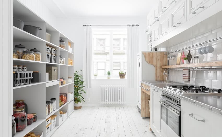Modern kitchen interior with white cabinets organised pantry items stainless steel counter top brick tile backsplash and kitchen hanging rods with hooks