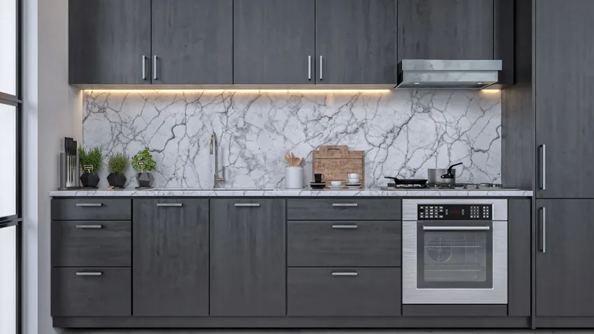 Modular kitchen marble backsplash dark gray cabinets lighting oven hood stove