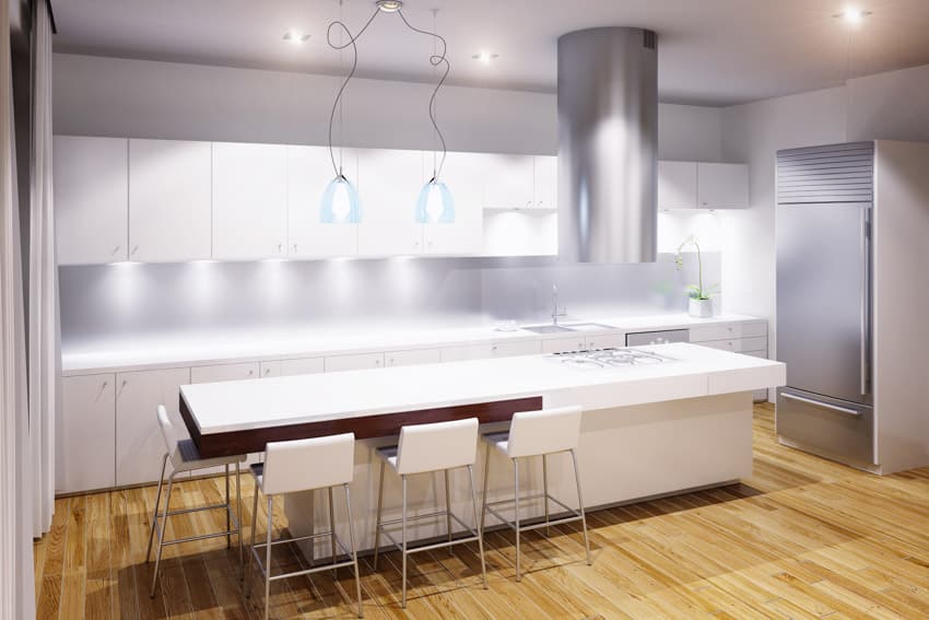 Nanoglass kitchen countertop on center island hood white cabinets under lighting wood flooring hanging lights