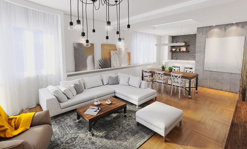 Open space living and dining room with matching coffee and dining table concrete accent wall white couch sheer curtains large pendant light and wooden parquet floor