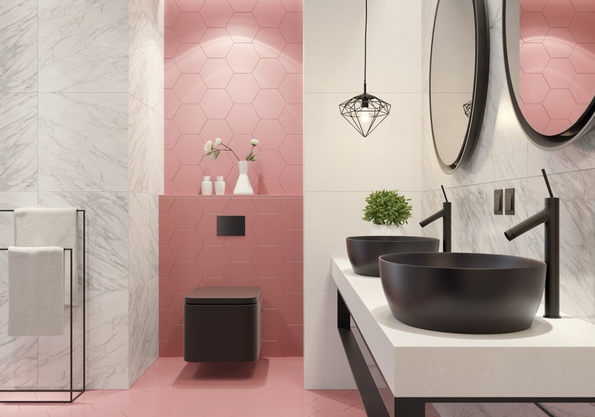 Pink accent wall matte black bathroom fixtures sink faucet toilet mirror pendant light