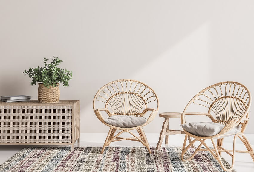 Room with white wall rug and wooden rattan armchairs with console 