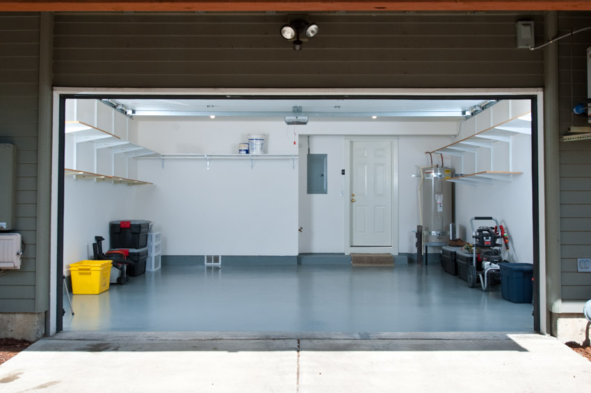 Sealed garage flooring, white wall and shelves