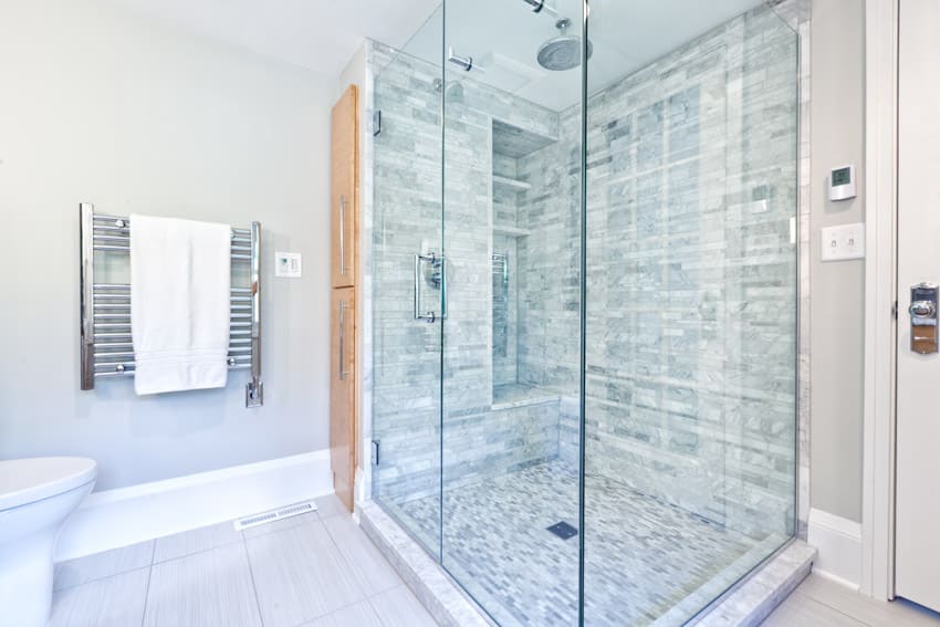 Shower with towel rack, toiled and glass enclosed shower area