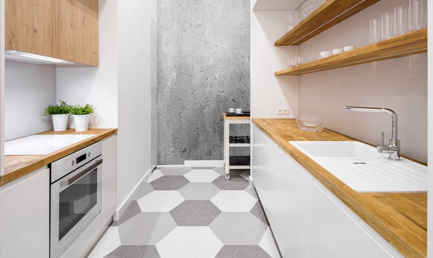 Small functional kitchen with baubuche countertop and hexagonal floor tiles
