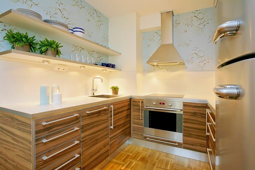 Small kitchen with open shelves stainless steel appliance wood cabinets and floors and white tile backsplash