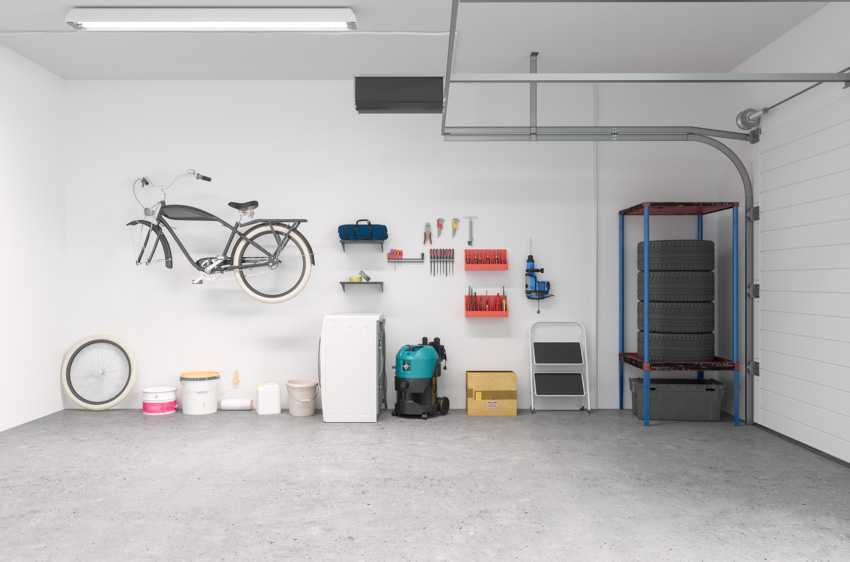 Spacious garage with sealed concrete floor ceiling light door opener white wall