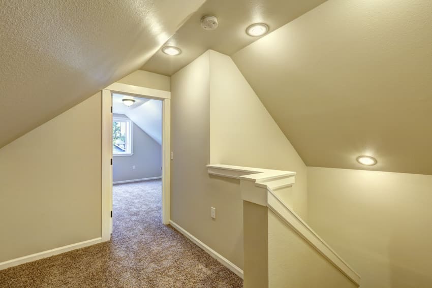 Staircase hallway white wall sloped ceiling flush mount lights