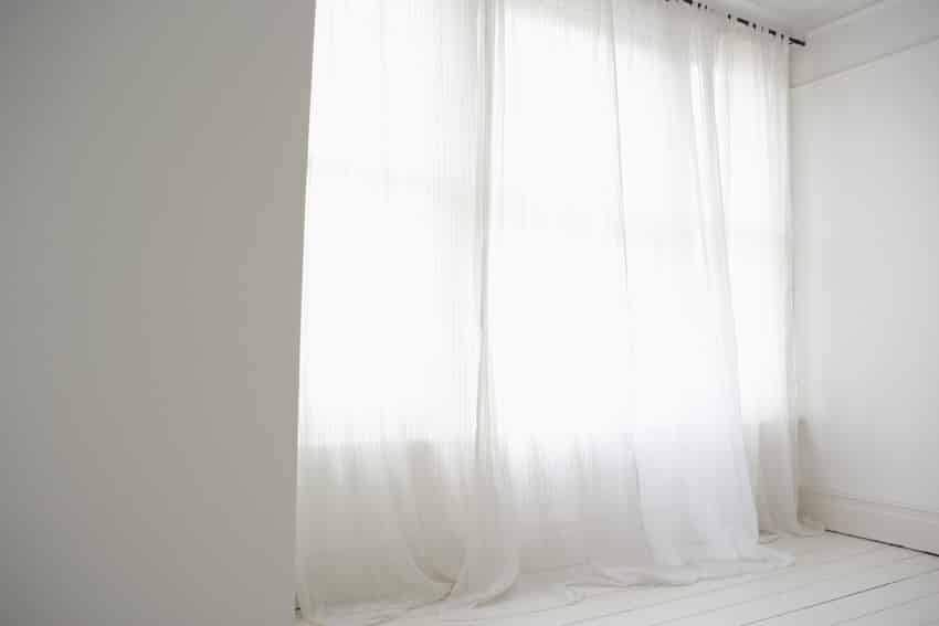 White sheer curtain wall rod windows