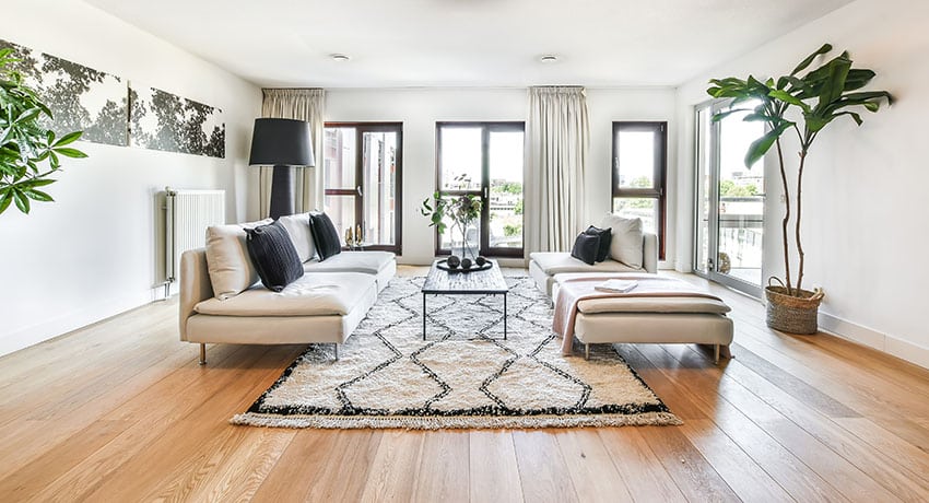 Living room with wooden flooring white paint large lamp shade indoor plant