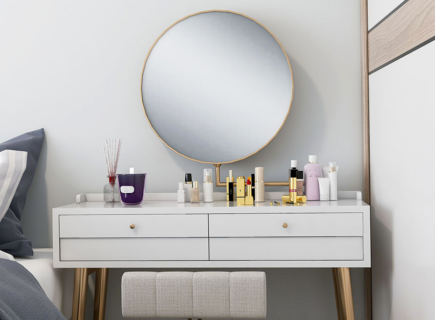 Makeup vanity with round metal framed mirror