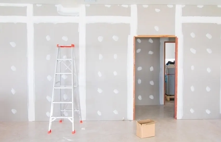 A-type ladder and drywall interior of home 