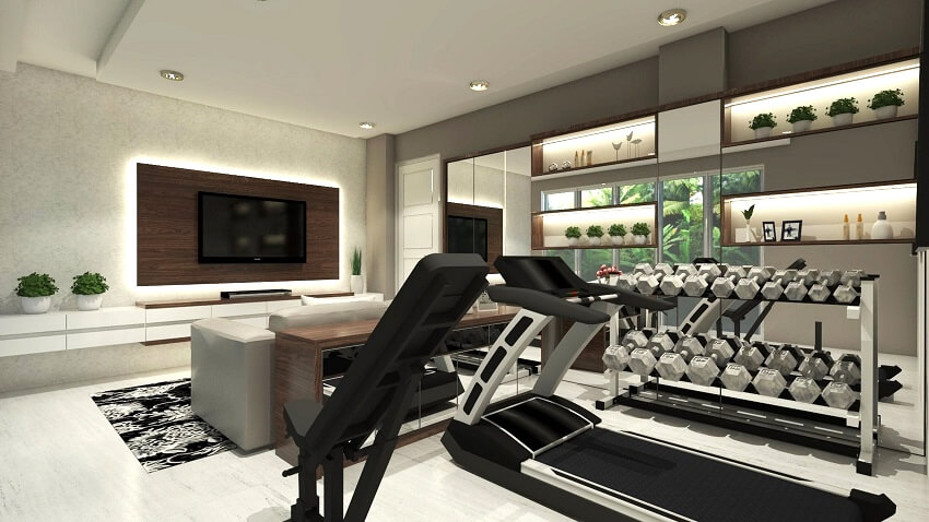 Basement home gym with television panel gym equipment display cabinet lighting fixtures couch and white and grey walls