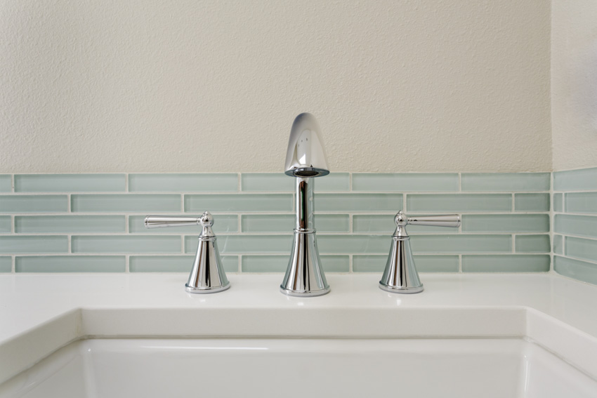 Bathroom sink with faucet in chrome finish and tiles