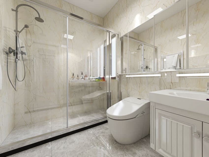 Bathroom with shower head, glass door, toilet, white cabinet, sink, and mirror