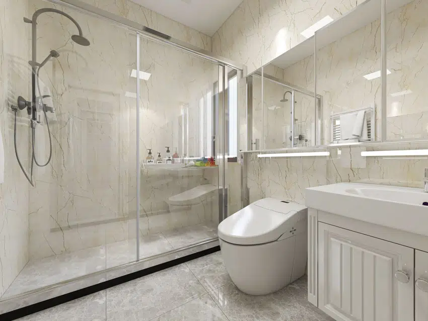 Bathroom with glass door, toilet, white cabinet, sink, shower, and mirror