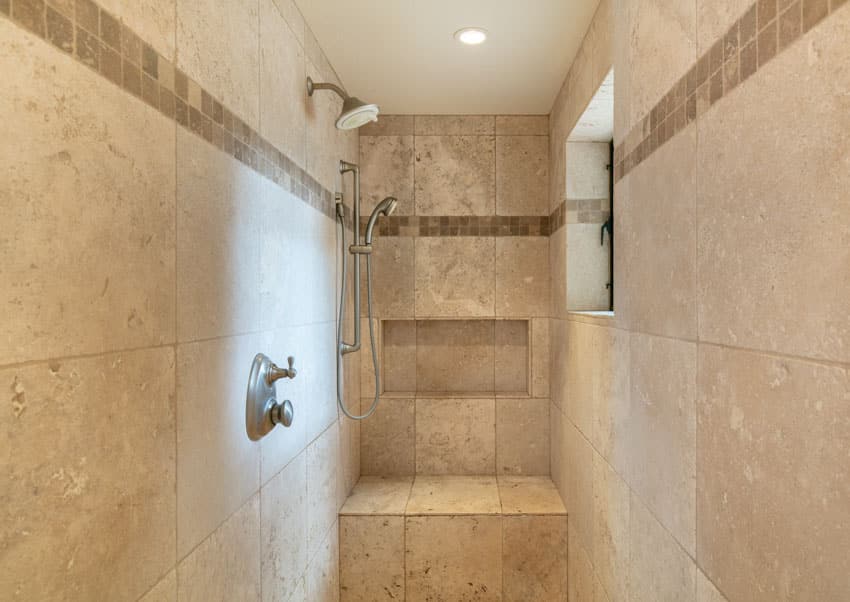 Bathroom with shower head, tile wall, and window