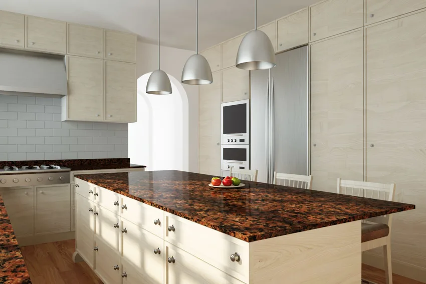 Beautiful kitchen with center island, gemstone countertops, pendant light, and cabinets