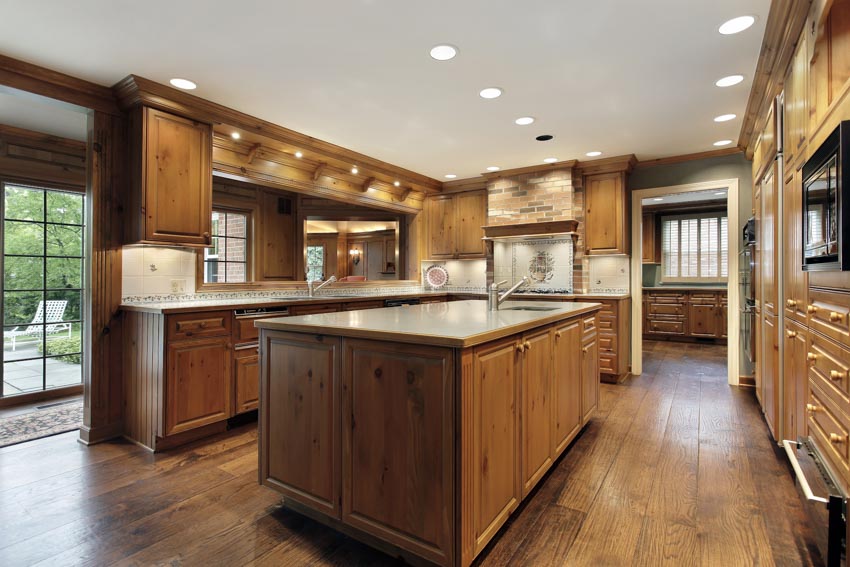 Beautiful kitchen with oak cabinets, wood flooring, center island, recessed lights, and backsplash