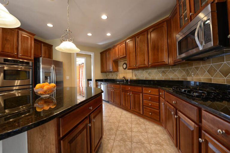 Beautiful Kitchen With Red Oak Cabinets Tile Floors Backsplash Recessed Ights And Countertop Is 768x512 