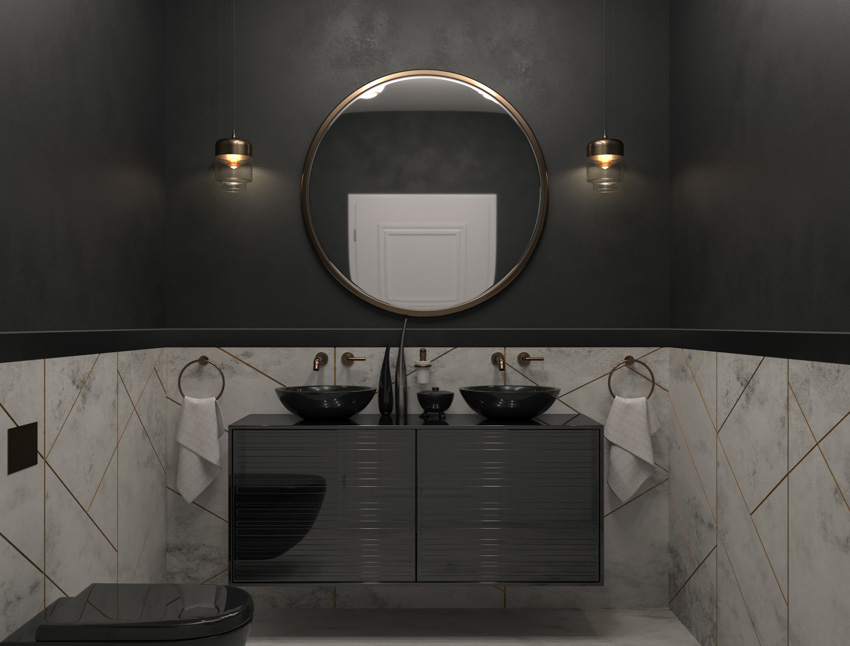 Black and white bathroom with brass faucets mirror sink towel holders