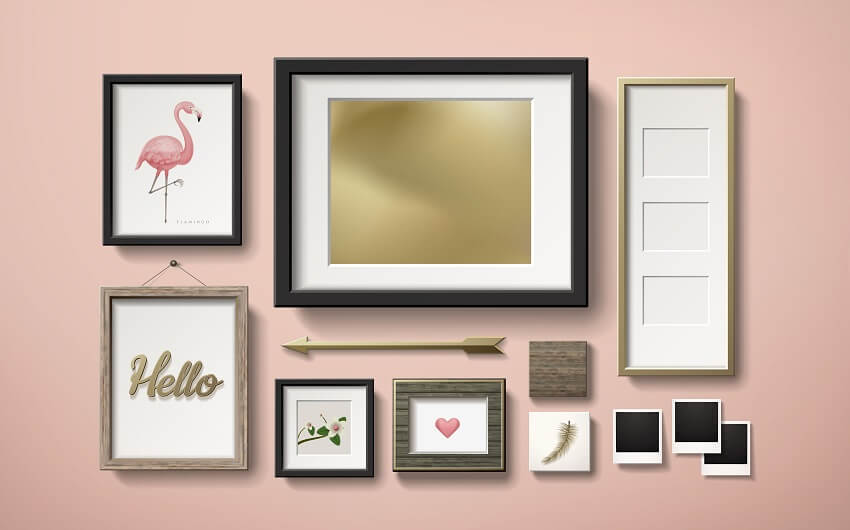 Blank picture frames decoration in different shapes and styles hanging on the pink wall