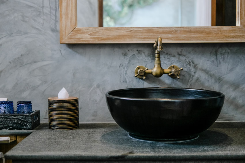 Brass bathroom faucet black basin sink mirror concrete wall countertop