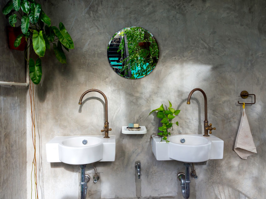 Brass faucets sink mirror concrete wall bathroom