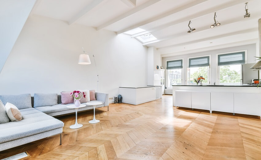 Grey sectional sofa and parquet flooring