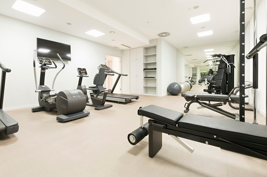 Bright white gym with carpet and rectangular flush mount lighting