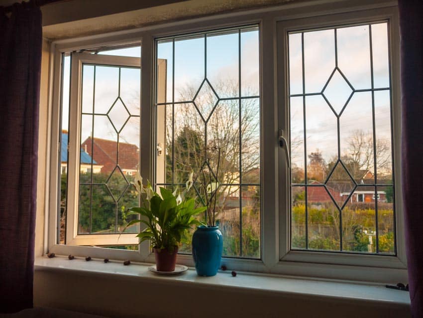 Casement windows with potted plants on the sill