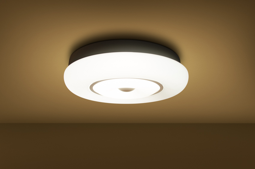 Ceiling lighting fixture on a brown colored ceiling