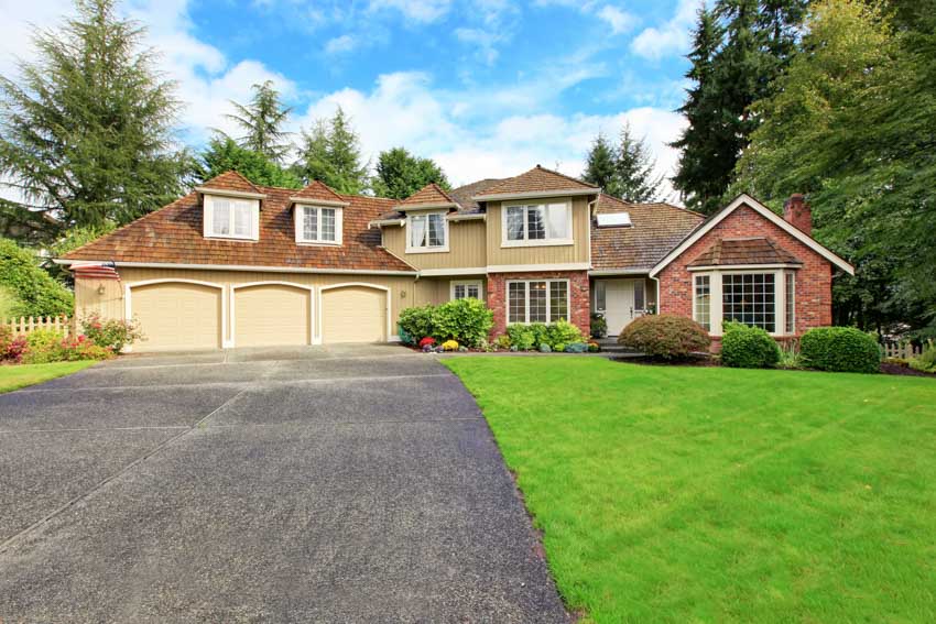 House with garage, driveway, dormers, and windows