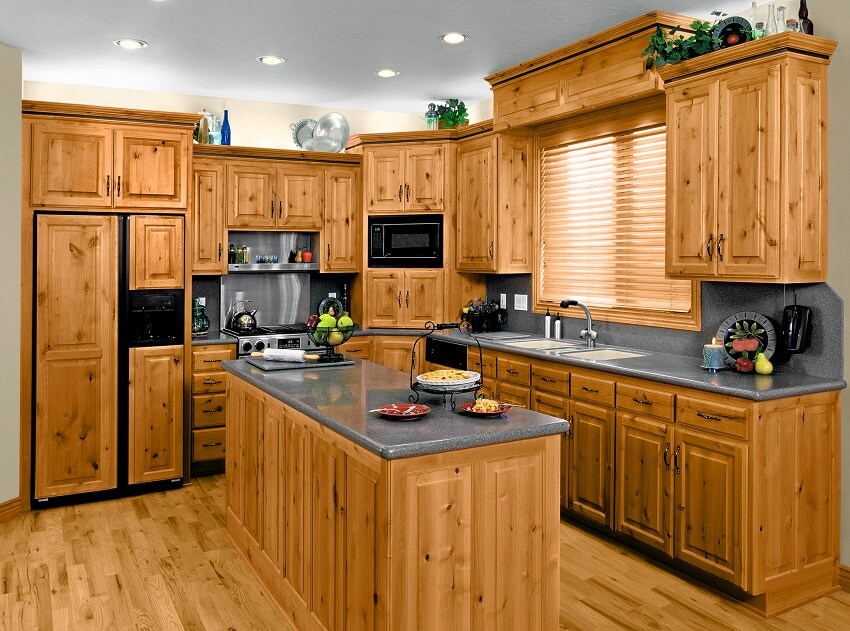 Contemporary kitchen with knotty wood cabinets and grey stone backsplash