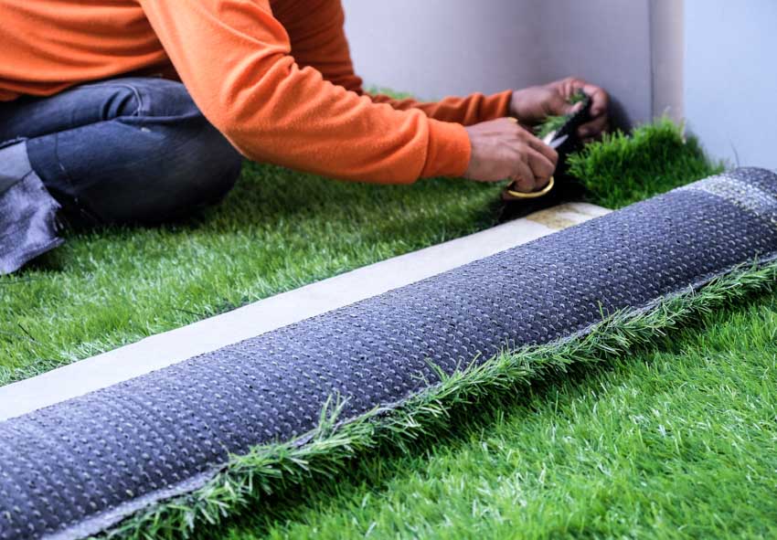 Contractor installing artificial turf for dogs