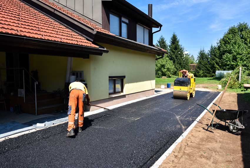 Contractors repairing the driveway