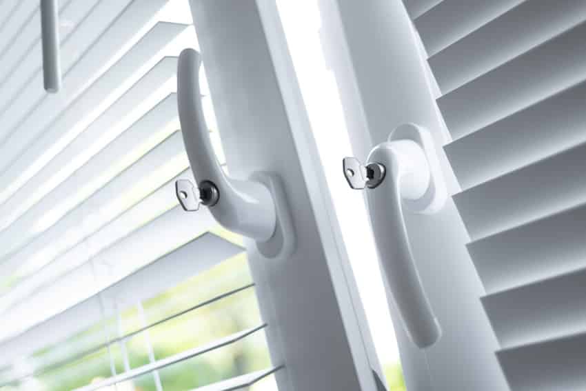 Crank handles of casement windows with shutter blinds
