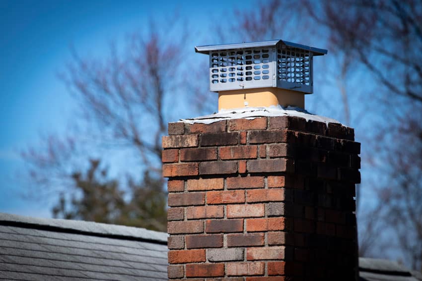 Damper on top of a brick chimney