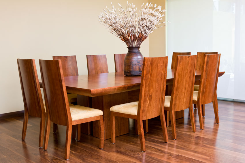 Dining space with centerpiece decor, table and chairs made of wood