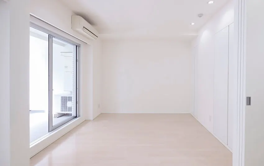 Apartment with glossy panel floor white walls and lighting fixtures 